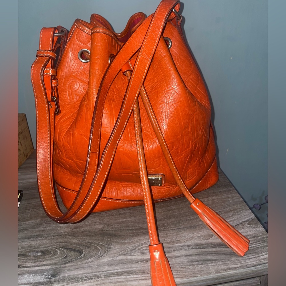 Bright orange leather Dooney and Bourke embossed logo bucket bag